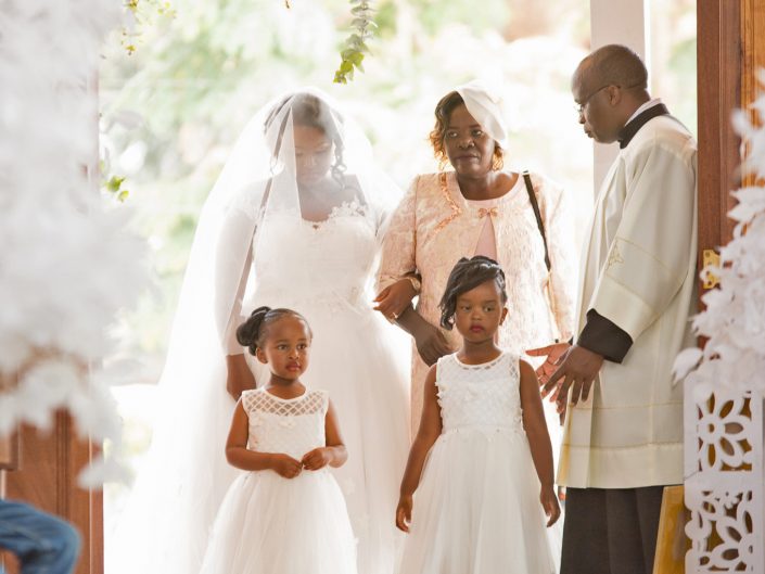 Wedding Photography, the bride walking down the isle with flower girls