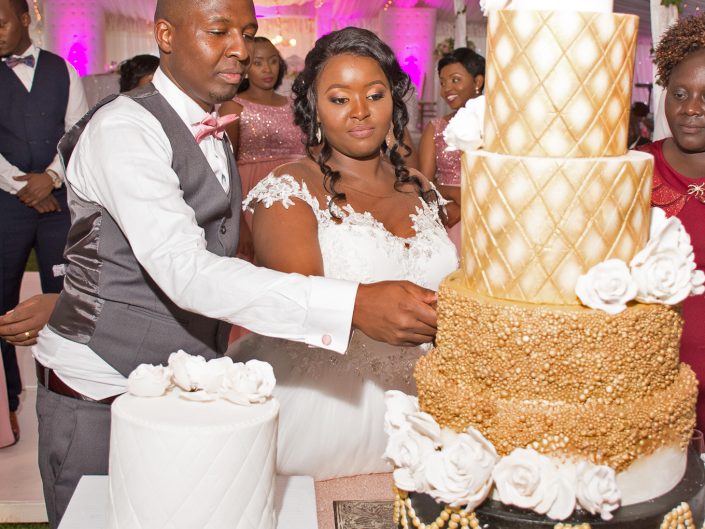 Luxury Wedding Photography The Groom and her Bride cutting cake at their wedding reception