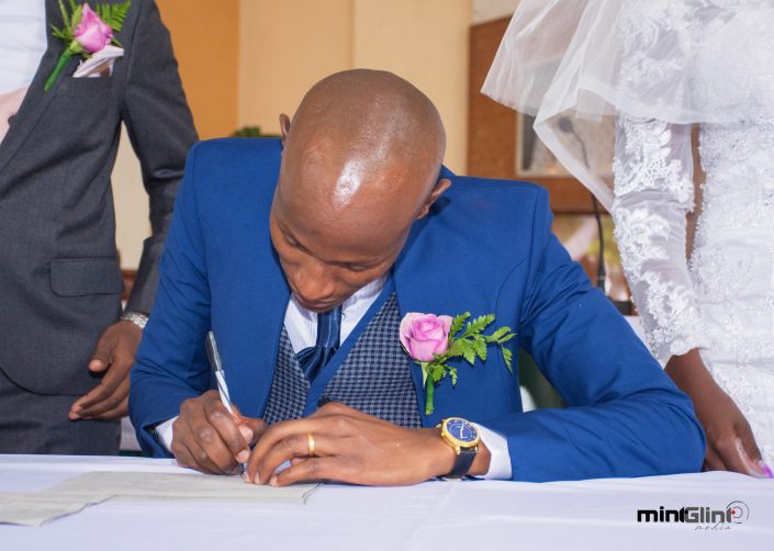 Wedding Photography by Mint Glint Media; The Groom signing the marriage certificate