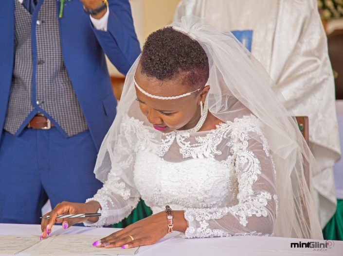 Wedding Photography by Mint Glint Media; The Bride signing the marriage certificate