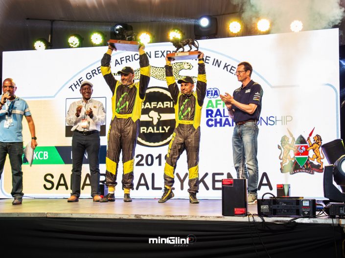 Baldev Chager and his navigator Ravi Soni celebrate their win of 2019 Safari Rally to the right is Oliver Ciesla - Managing Director - WRC Promoter GmbH and to the left is Phineas Kimathi the CEO of Safari Rally Project in Kenya.