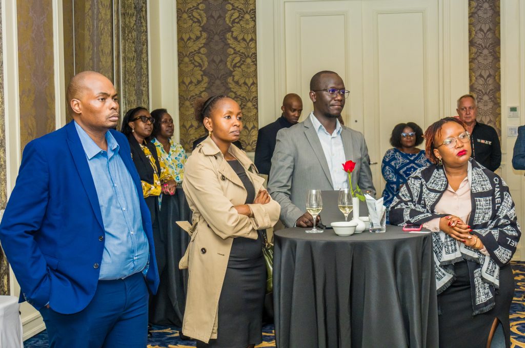 Four attendees looking attentively at a speaker during a JBQ Africa corporate event, captured by Mintglint Media, the best AV company in Nairobi Kenya.