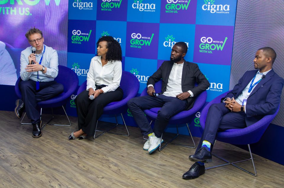 A group of colleagues at Cigna Healthcare engaged in a team discussion during a meeting. Descriptive:
